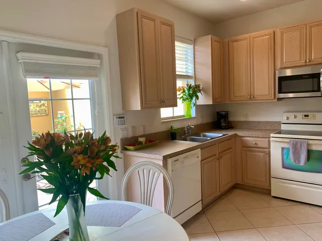 a kitchen with a refrigerator and a sink