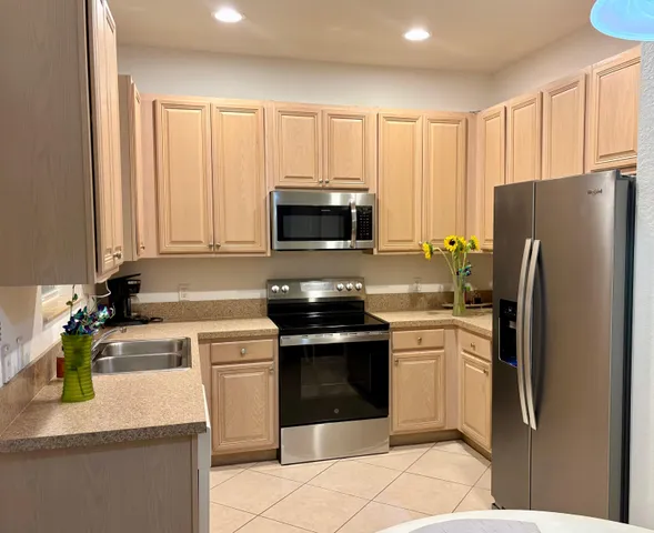 a kitchen with a sink stove and refrigerator