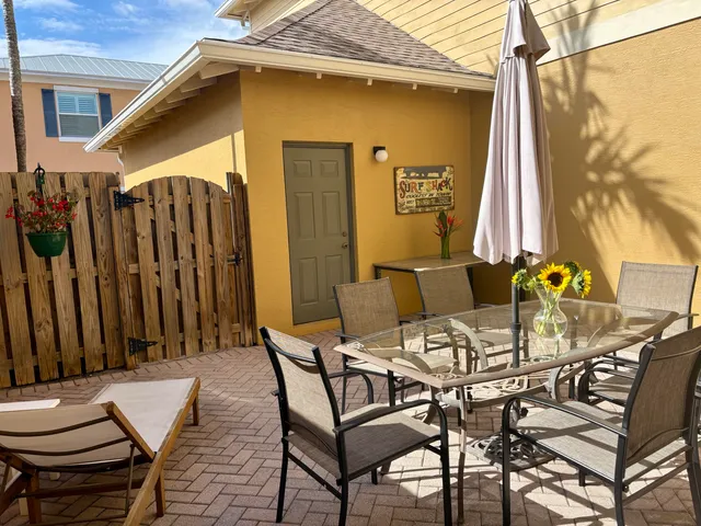 a view of a patio with a table and chairs