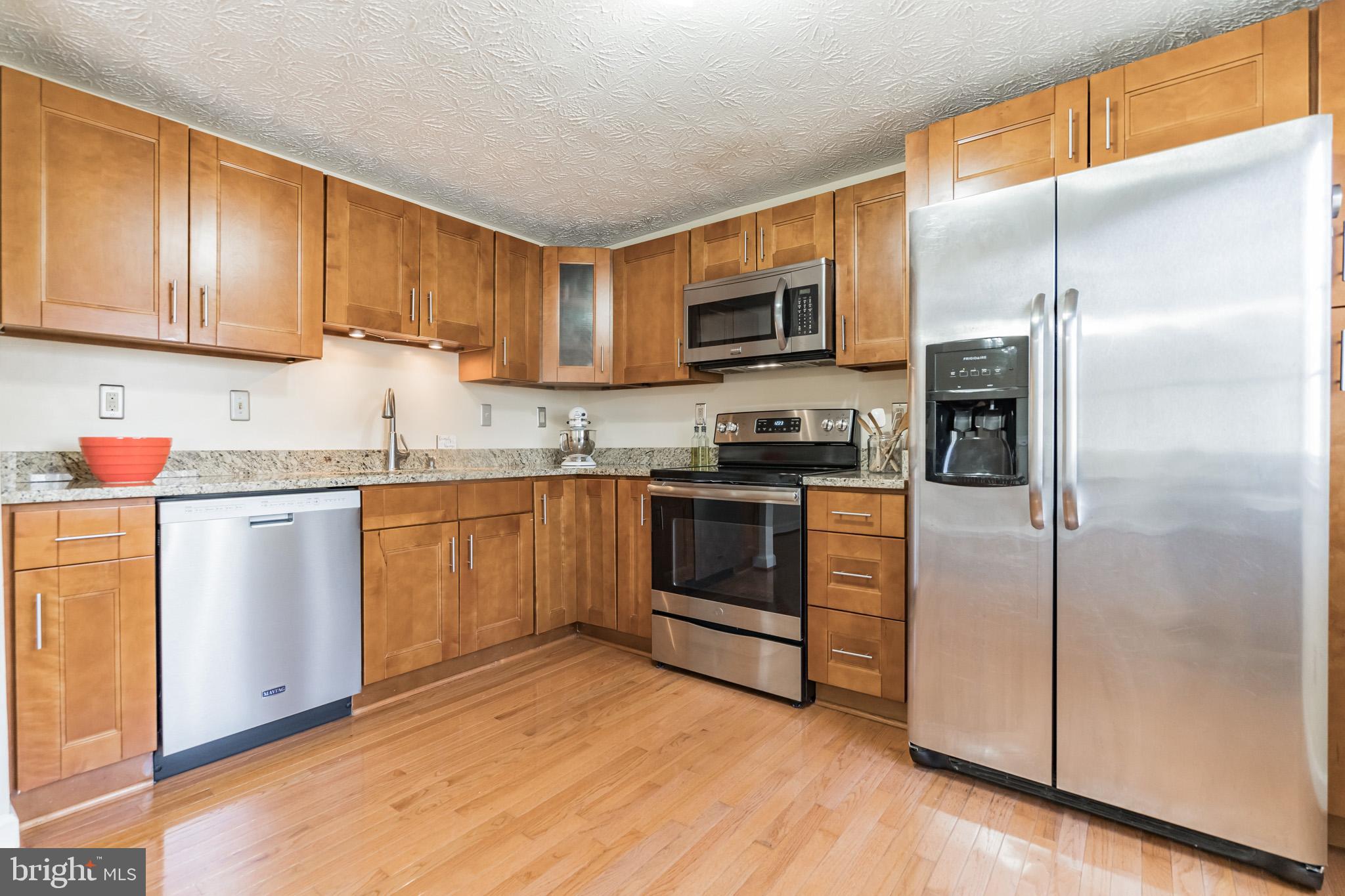 1610 Barnstead Drive Reston, VA 20194 - Photo 8 of 33 a kitchen with stainless steel appliances granite countertop a refrigerator sink and microwave