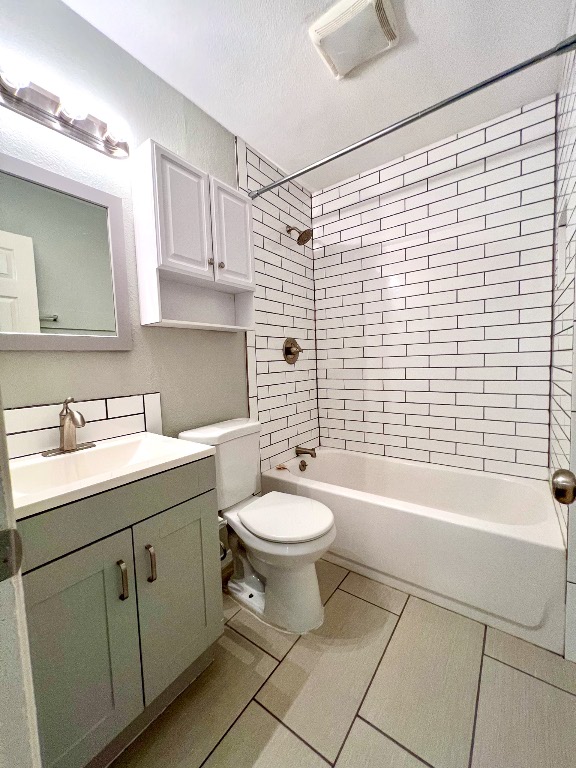 9703 Roxanna Drive, Unit D Austin, TX 78748 - Photo 20 of 24 Full bathroom with shower combination, vanity, light tile patterned flooring, and a textured ceiling