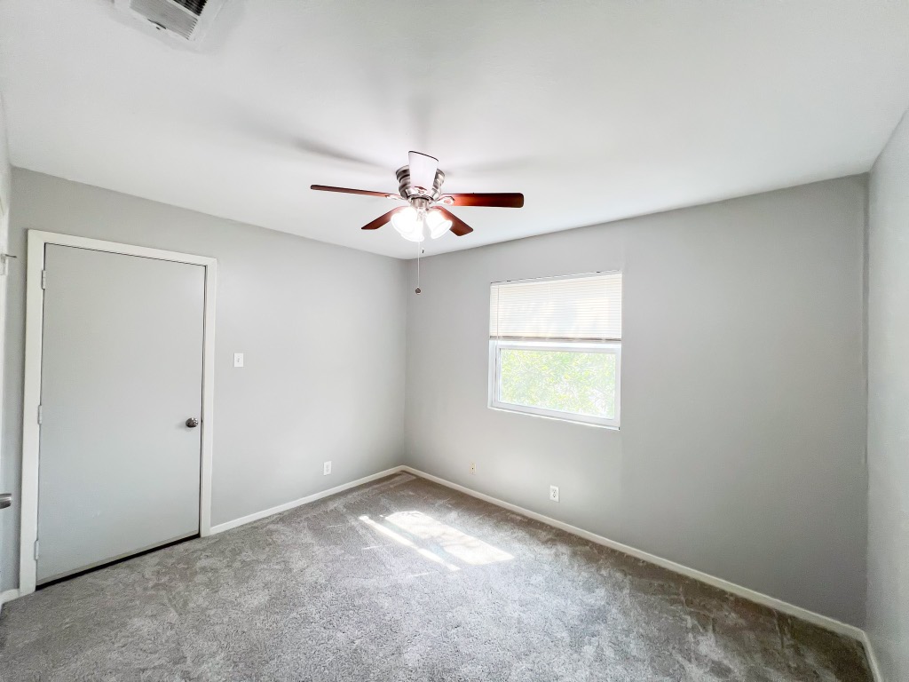 9703 Roxanna Drive, Unit D Austin, TX 78748 - Photo 22 of 24 Unfurnished bedroom with carpet flooring and a ceiling fan