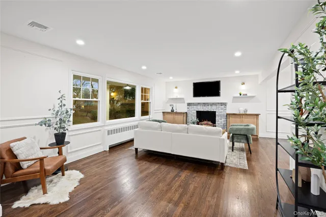 a living room with furniture a fireplace and a flat screen tv