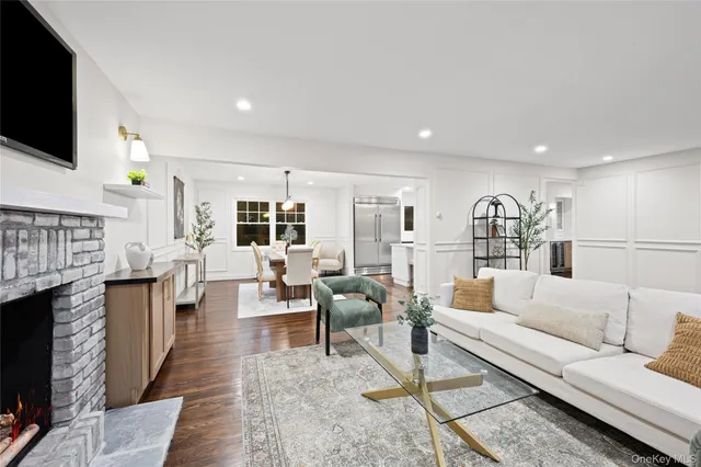 a living room with fireplace furniture and a flat screen tv