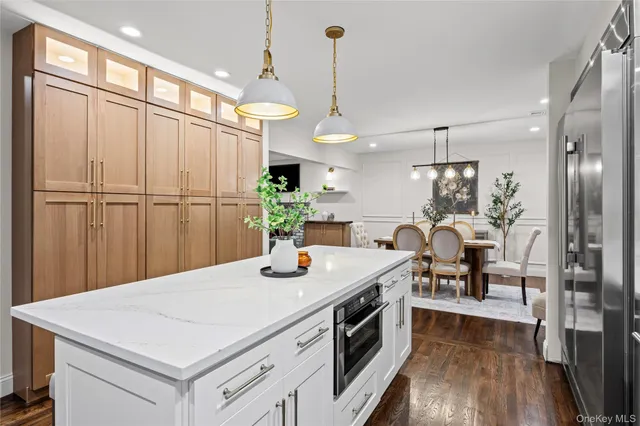a kitchen with a table chairs refrigerator and microwave