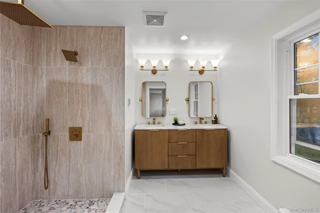 a view of hall way with mirror and window