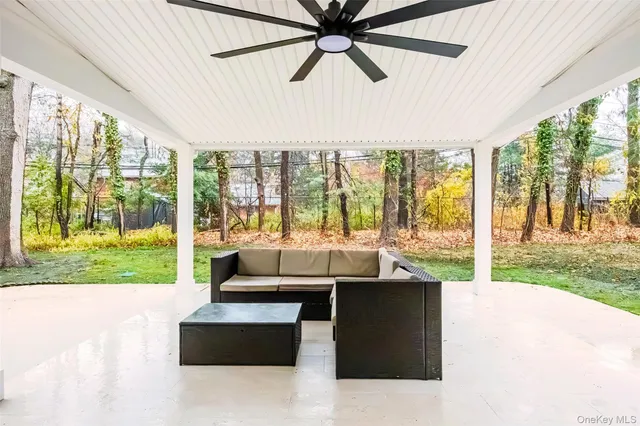 a living room with furniture and a floor to ceiling window