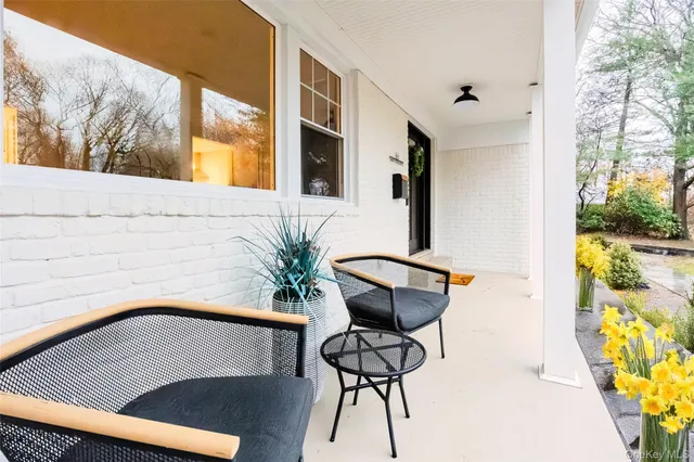 a view of a chairs and table in the balcony