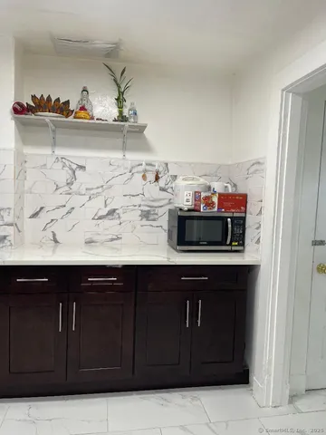 a view of kitchen cabinets and microwave