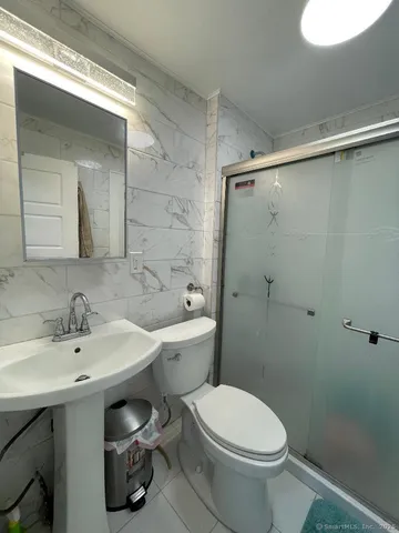 a bathroom with a sink toilet and shower