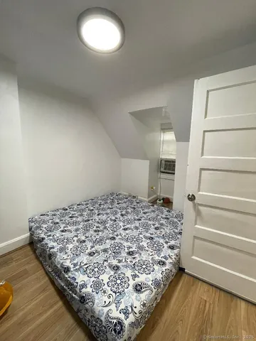 a bed sitting in a room next to a window