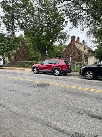 front view of a house with a cars parking space