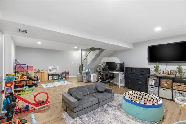 a living room with furniture a flat screen tv and a table