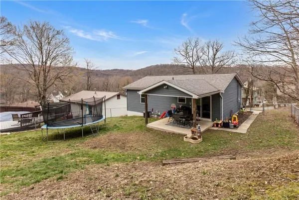 a view of a backyard with furniture and garden