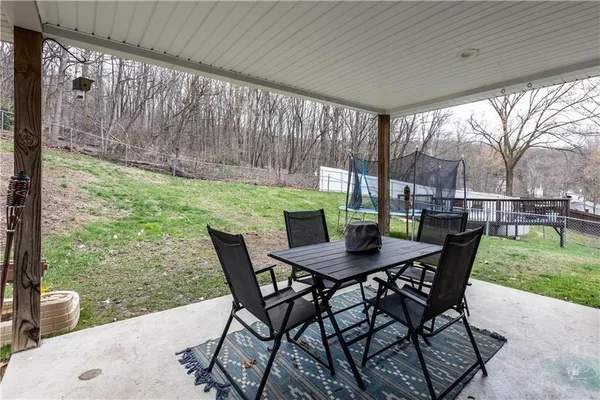a view of a backyard with chair and tables