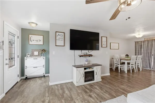 a view of a livingroom with furniture flat screen tv and wooden floor