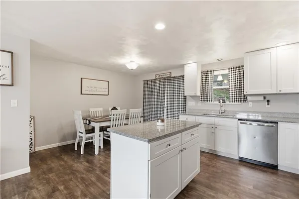 a kitchen that has a sink and a stove in it