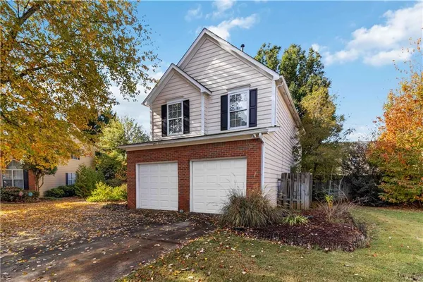 a front view of a house with a yard garage and outdoor seating