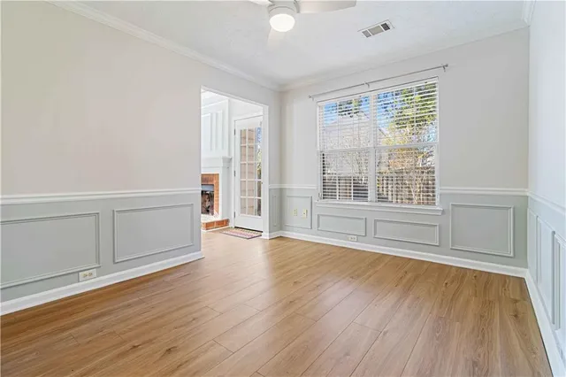 wooden floor in an empty room with a window