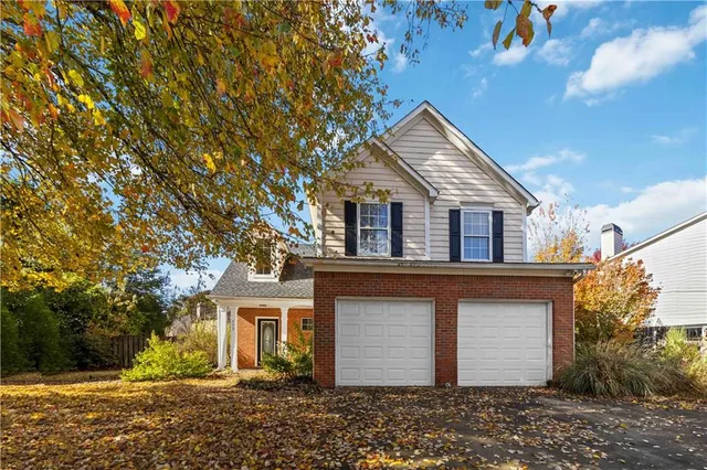 a house that has a tree in front of it