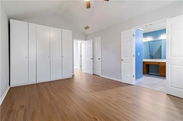 an empty room with wooden floor and fireplace