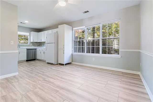 a view of kitchen with a sink dishwasher and microwave