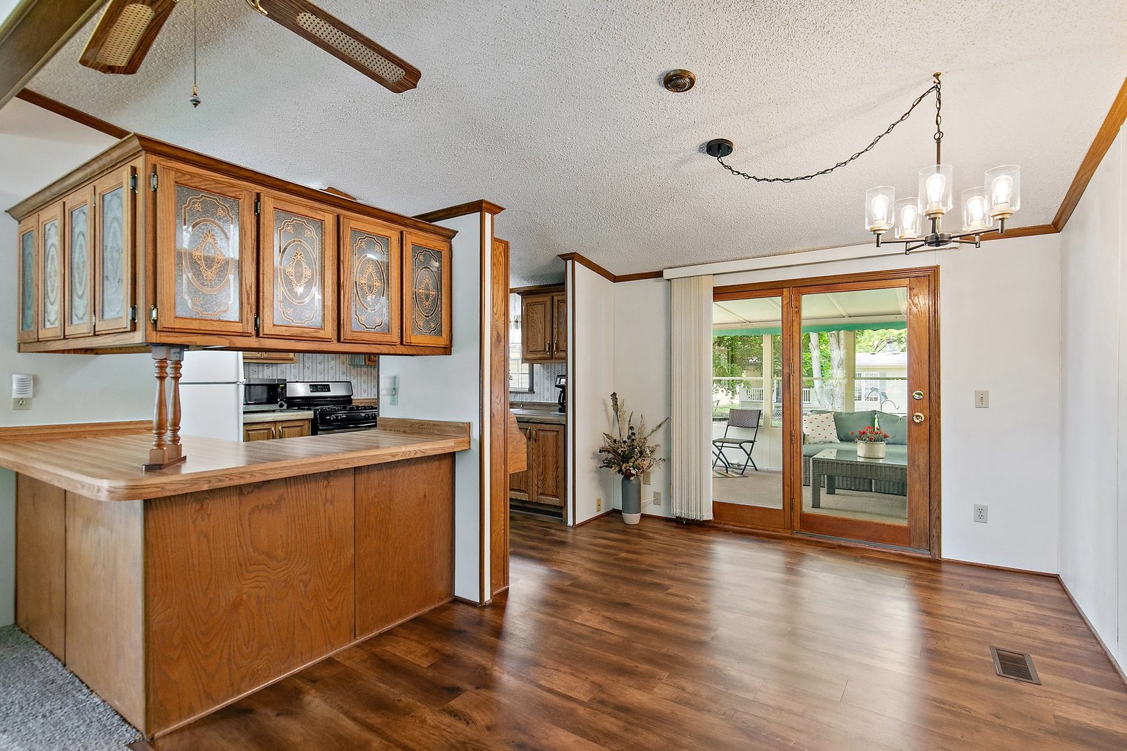 8566 Fig Tree Lane Roscoe, IL 61073 - Photo 4 of 14 a kitchen with stainless steel appliances granite countertop a refrigerator a stove and a wooden floors