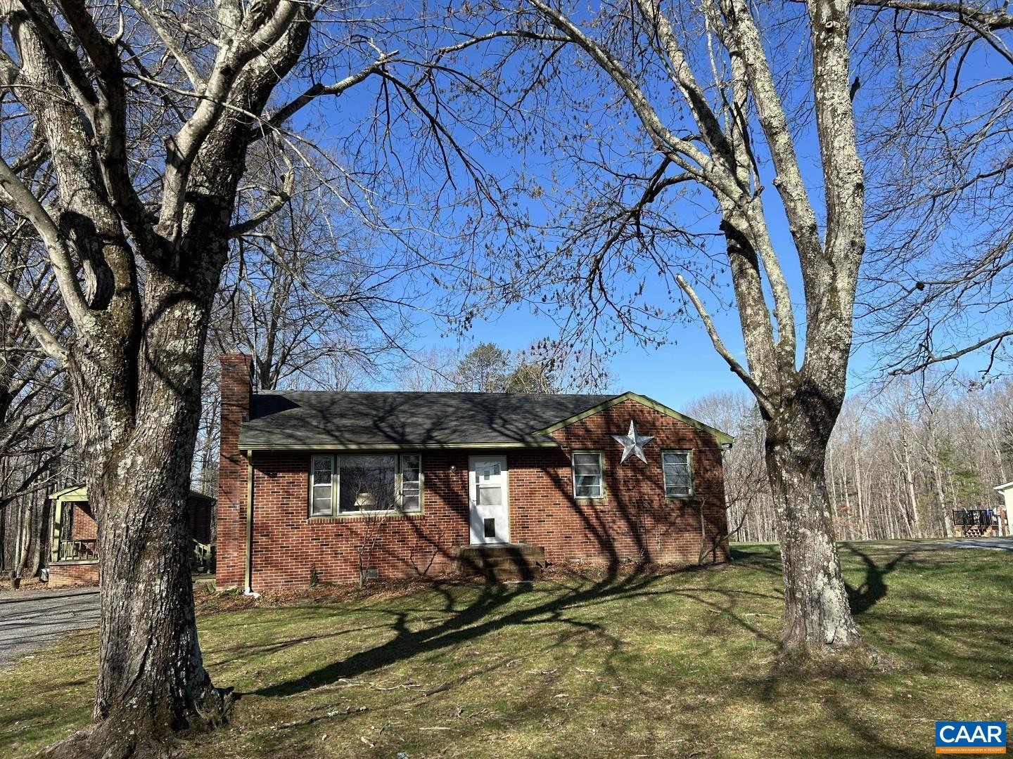 a view of a wooden house with a yard