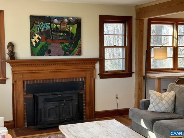 a living room with a fireplace and windows