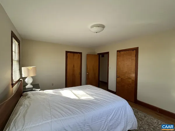 a bedroom with a bed and a mirror