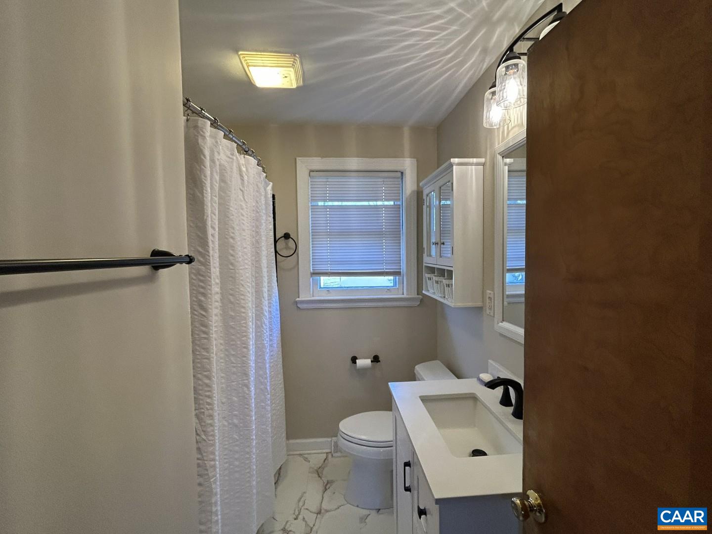 7714 Blenheim Road Scottsville, VA 24590 - Photo 21 of 35 a bathroom with a sink toilet and shower