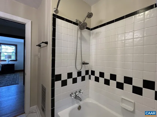 a bathroom with a black and white checkered floor