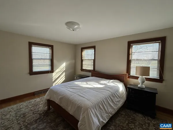 a bedroom with a bed and with windows