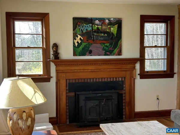 a living room with a fireplace and a window