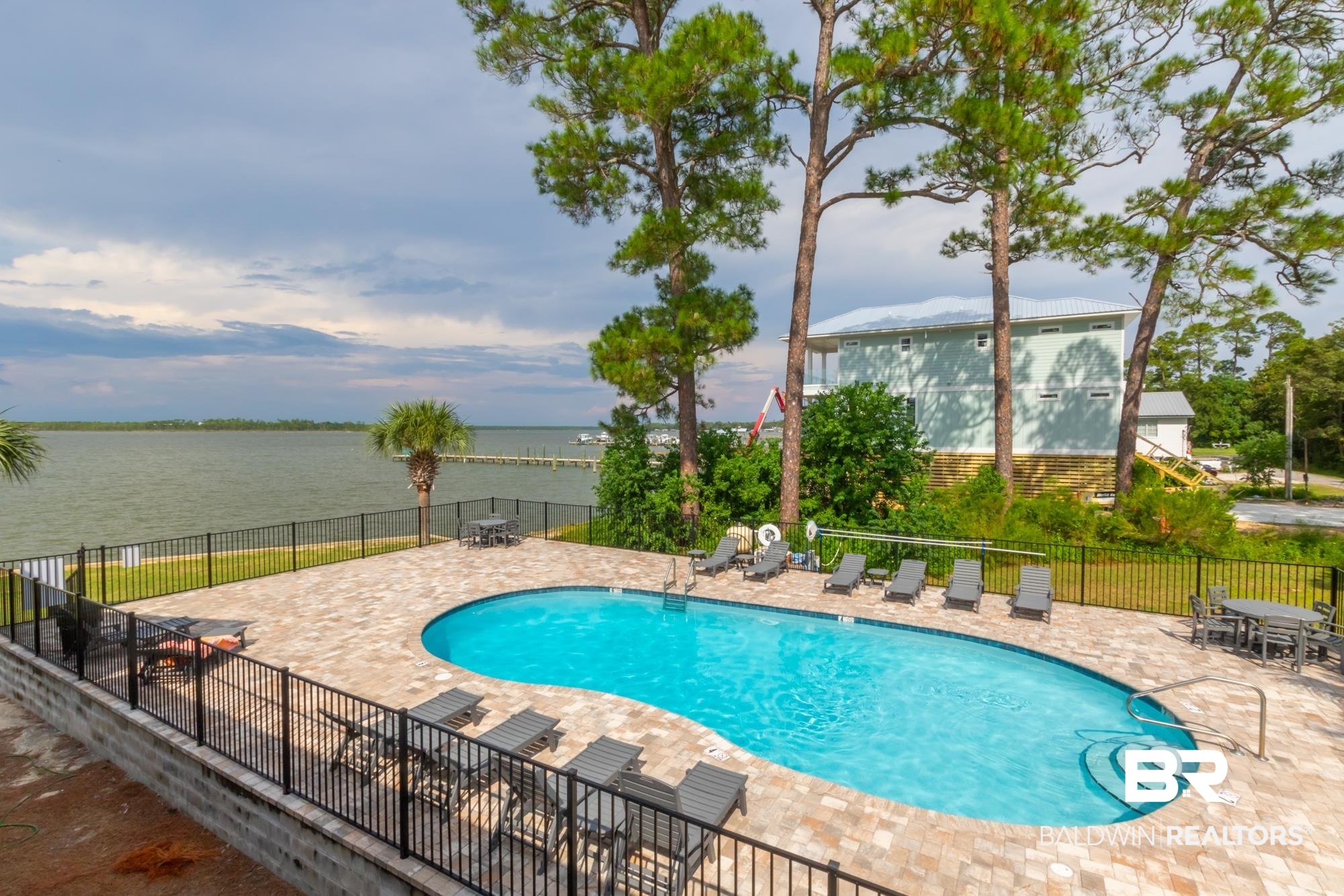 25925 -C Canal Road, Unit 203 Orange Beach, AL 36561 - Photo 27 of 57 View of swimming pool with a patio and a water view