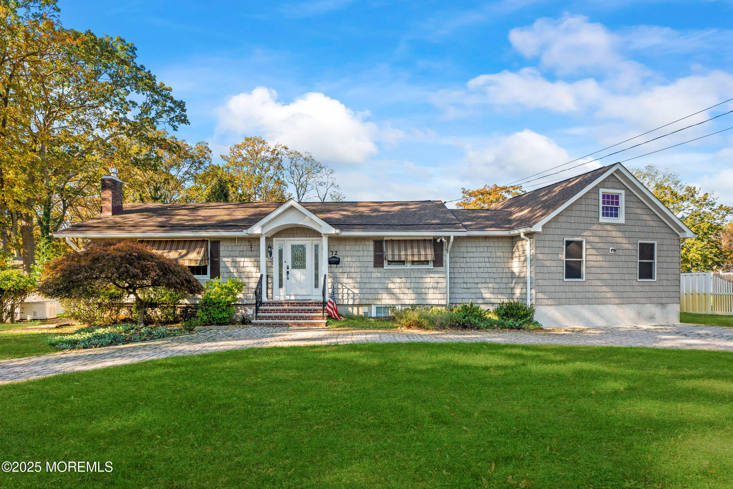 a front view of a house with a garden and plants