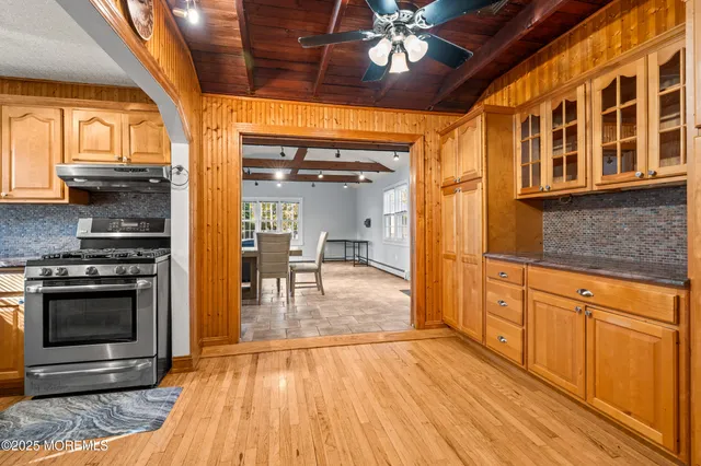 a dining room with furniture a rug and a large window