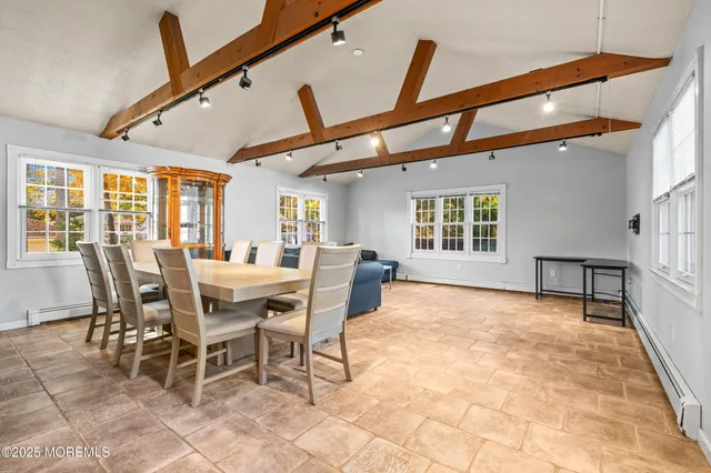 a view of a dining room with furniture and a chandelier