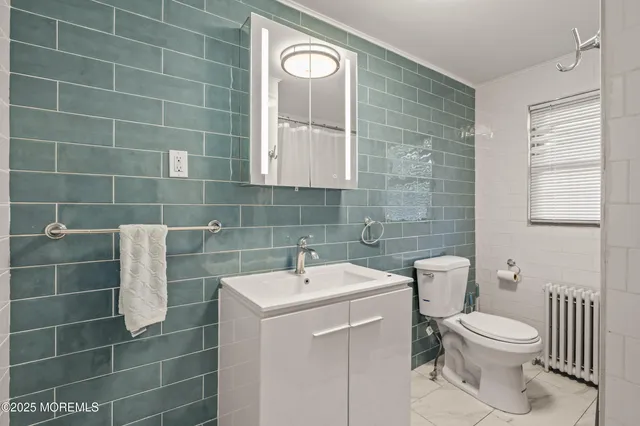 a spacious bedroom with a bed and a dresser