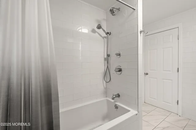 a room with a bed and a ceiling fan