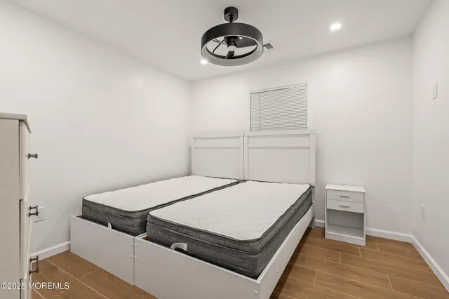 a bedroom with a bed and a fan