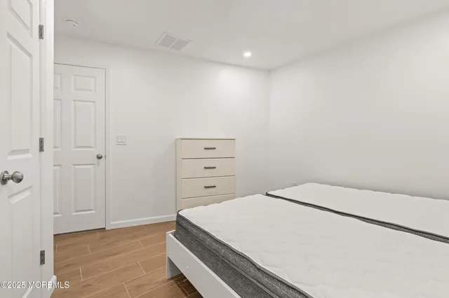 a bed sitting in a bedroom and chair