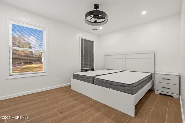 a room with a bed and a night stand