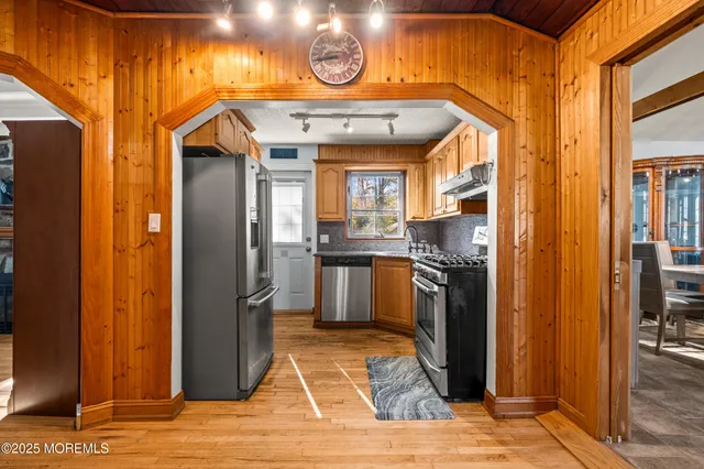 a kitchen with stainless steel appliances granite countertop a refrigerator and a sink