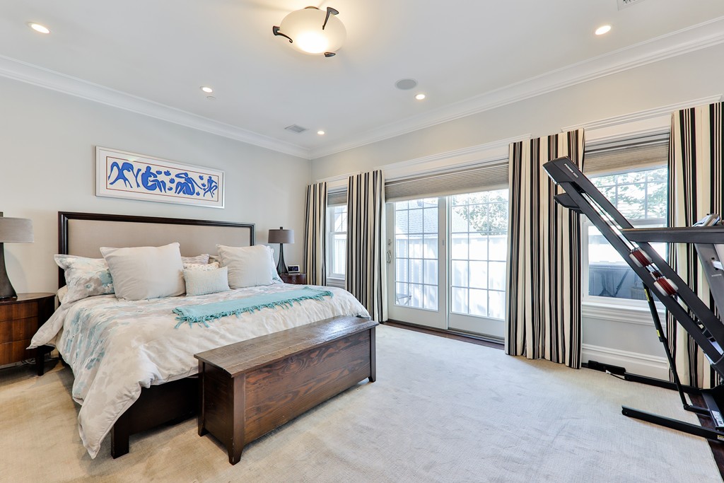 161 Tudor Street, Unit 4 Boston, MA 02127 - Photo 13 of 28 a bedroom with a large bed and a chandelier