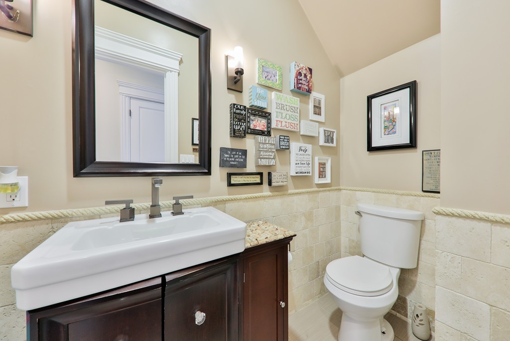 161 Tudor Street, Unit 4 Boston, MA 02127 - Photo 20 of 28 a bathroom with a toilet sink and mirror