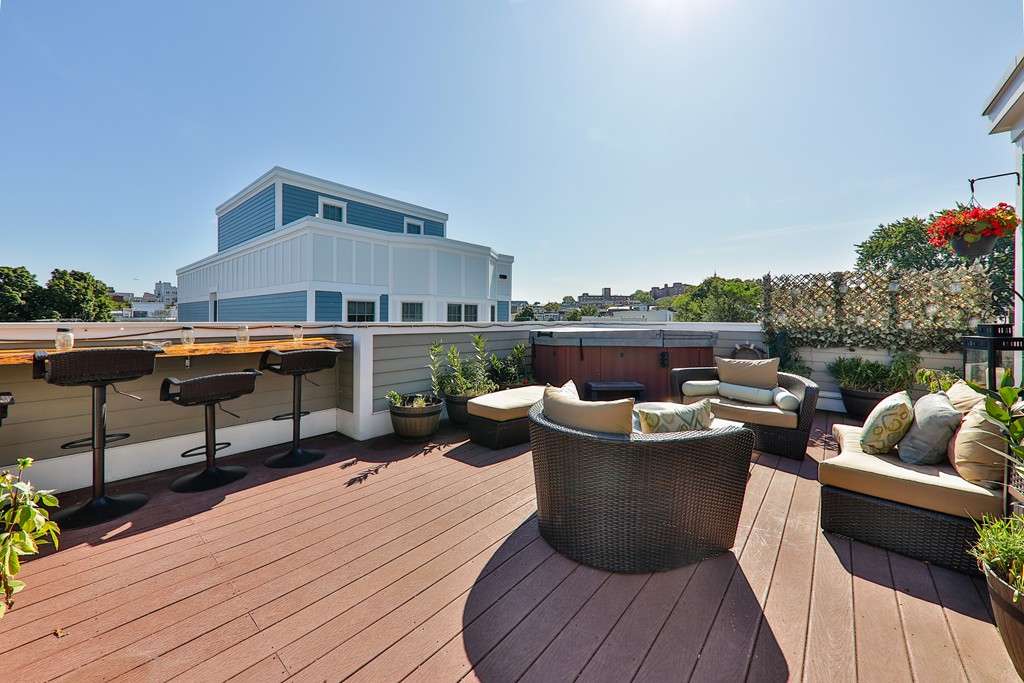 161 Tudor Street, Unit 4 Boston, MA 02127 - Photo 22 of 28 a roof deck with a table and chairs