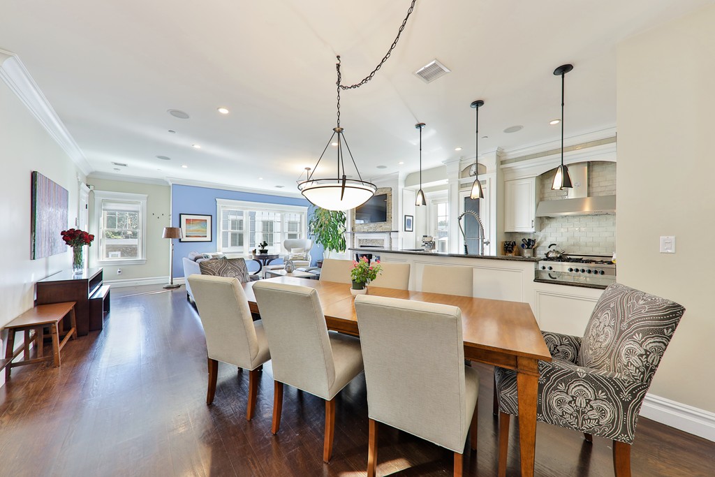 161 Tudor Street, Unit 4 Boston, MA 02127 - Photo 7 of 28 a view of a dining room and livingroom with furniture wooden floor kitchen chandelier