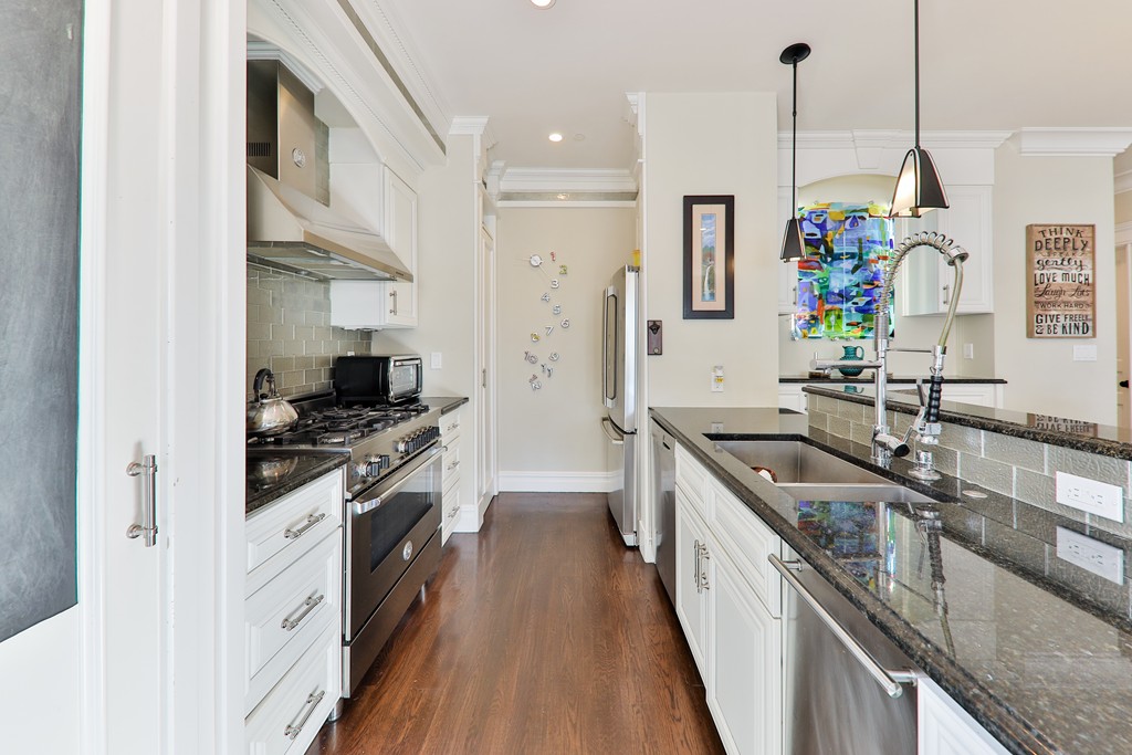 161 Tudor Street, Unit 4 Boston, MA 02127 - Photo 10 of 28 a kitchen with stainless steel appliances granite countertop a sink stove and refrigerator