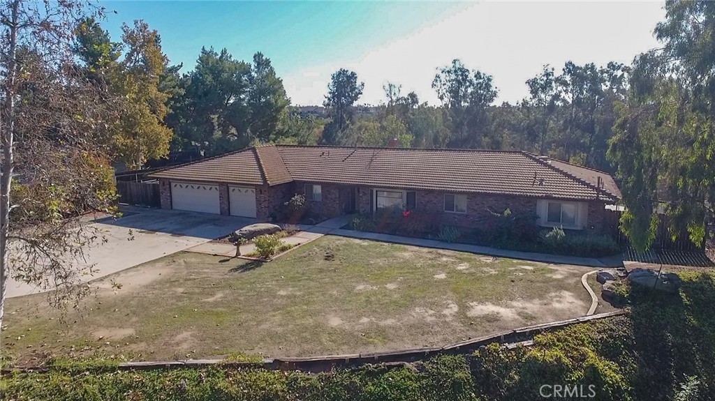 14465 Bush Avenue Riverside, CA 92508 - Photo 1 of 1 a view of a small house with yard and sitting area